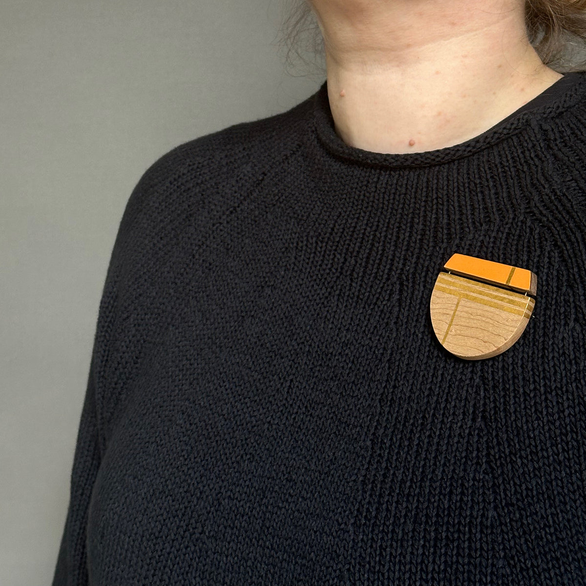 Orange curve brooch